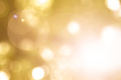 Warm yellow gold color of blurred sky background with nature glowing sun light flare and bokeh