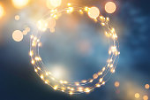 Defocused light background with circular light garland and copy space for your text