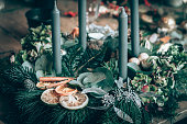 preparing traditional advent wreath with candles, baubles, natural components, pine fir and adorns