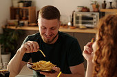 Young man enjoying lunch with girlfriend