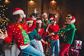 Photo of cheerful young people friends group good mood dancing cheerful smile cozy christmas party decor spacious apartment indoors