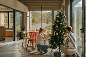 Couple is decorating a Christmas tree