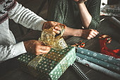mature couple wrapping christmas presents