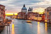 Sunrise view of Grand Canal traffic and Basilica di Santa Maria della Salute, Venice, Italy