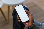 Man using smartphone with blank white screen mockup