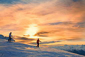 Snow skiers couple  Enjoying a beautiful winter mountains  sunset landscape