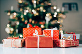 Lots of christmas presents on a table