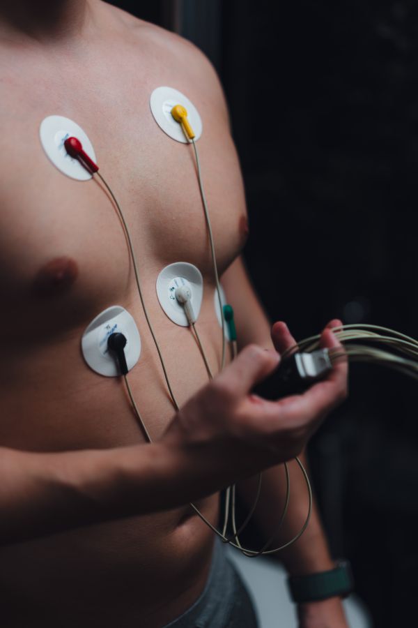 Man Being Monitored for Heart Activity at Home with Holter ECG Monitor Free Photo