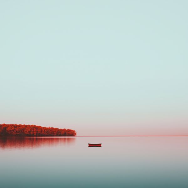 Minimalist Photo of a Boat in the Middle of a Lake Free Image