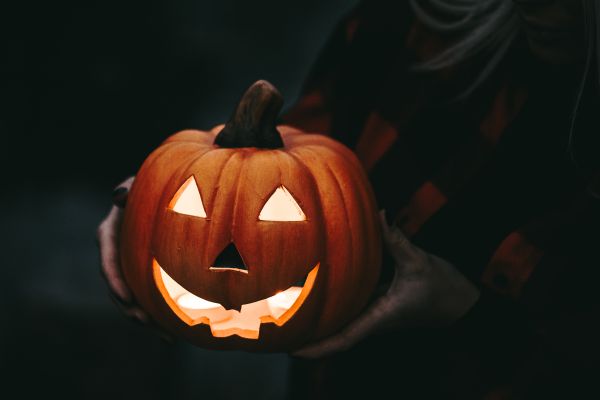 Woman Holding a Carved Halloween Pumpkin Free Photo