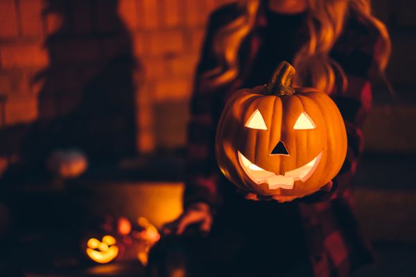 Woman Holding a Halloween Pumpkin in Dark Night Free Photo