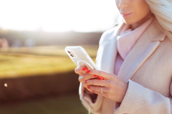 Young Woman in Fall Coat Using Her Smartphone Free Photo